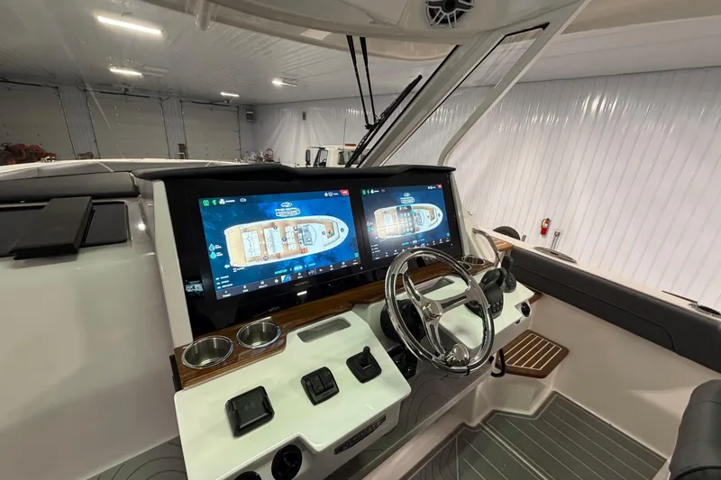 Slide: The Image of 2027 Regal 38 Surf boat cockpit with dual touchscreen displays and modern steering wheel. - 32