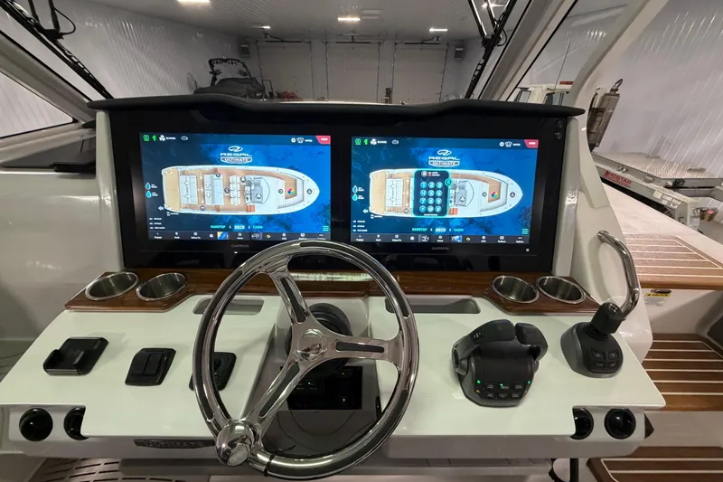 Slide: The Image of Cockpit of 2027 Regal 38 Surf boat with dual navigation screens and controls. - 34