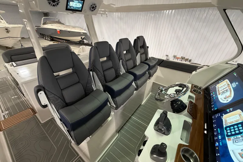 Slide: The Image of Interior of 2027 Regal 38 Surf boat with modern seating and advanced control panel. - 36