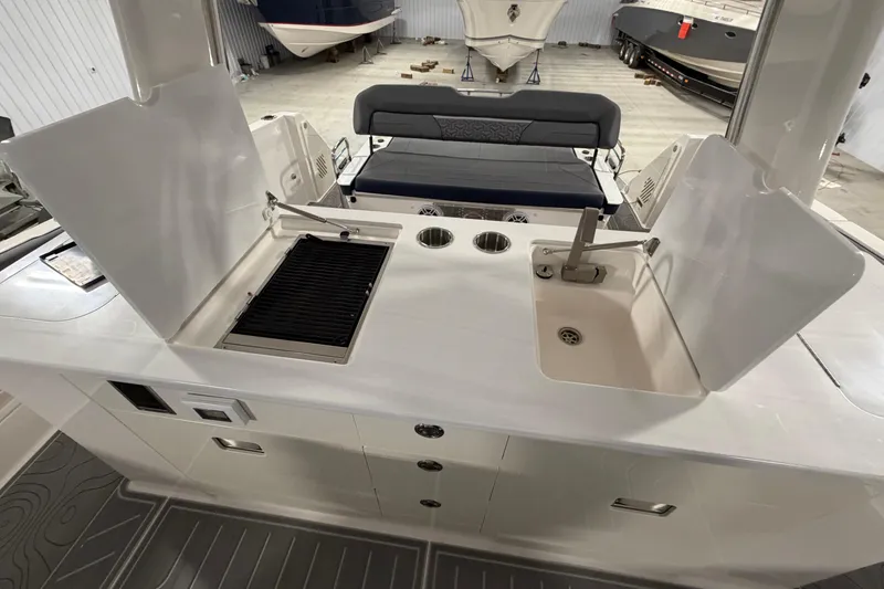 Slide: The Image of 2027 Regal 38 Surf boat interior with grill and sink in a spacious layout. - 4