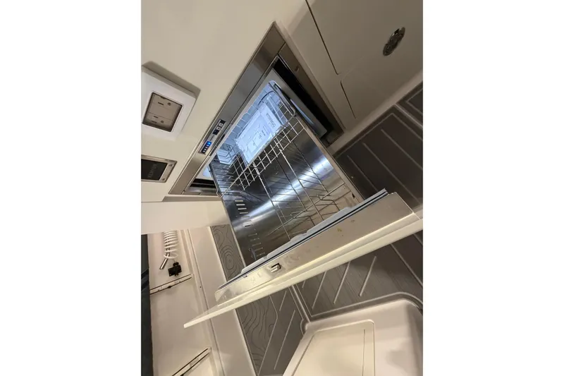 Slide: The Image of Open dishwasher inside a 2027 Regal 38 Surf boat kitchen area. - 5