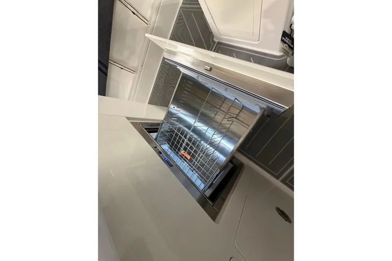 Slide: The Image of Open dishwasher in the galley of a 2027 Regal 38 Surf boat. - 6