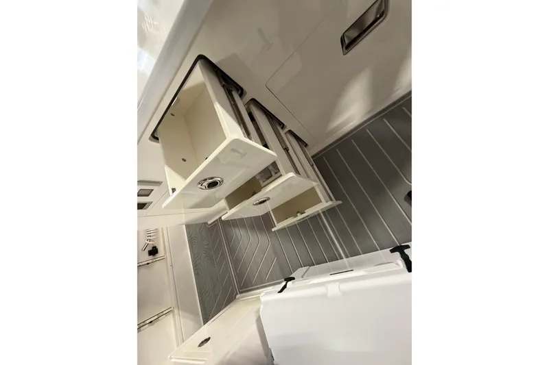Slide: The Image of 2027 Regal 38 Surf boat interior with open storage compartments and sleek design. - 7