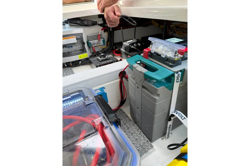 Slide: The Image of Battery compartment of 2025 Saxdor 320 GTC boat, showcasing electrical components and wiring. - 46
