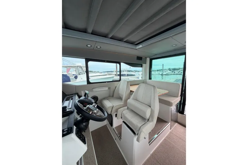 Slide: The Image of Interior of 2025 Saxdor 320 GTC boat with modern helm and seating area. - 23