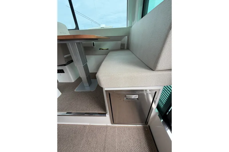 Slide: The Image of Interior of 2025 Saxdor 320 GTC featuring a cushioned seat and stainless steel storage. - 18
