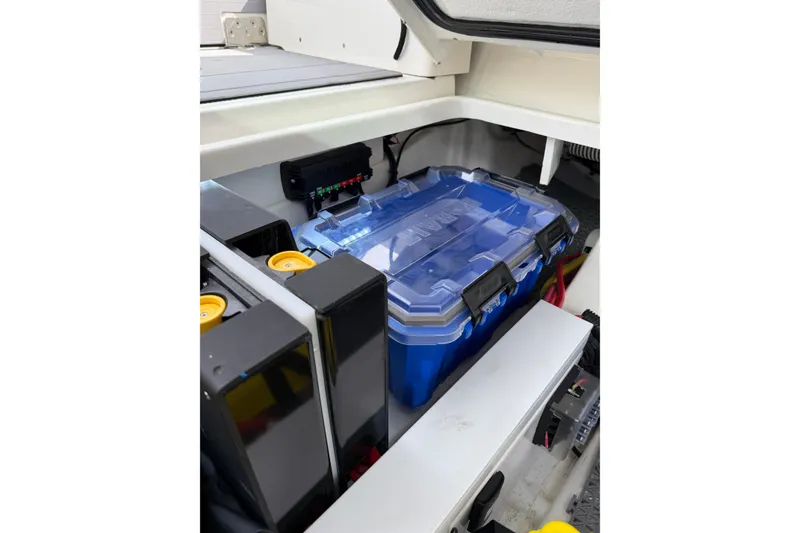 Slide: The Image of Battery compartment of 2025 Saxdor 320 GTC boat, featuring a blue battery box. - 45