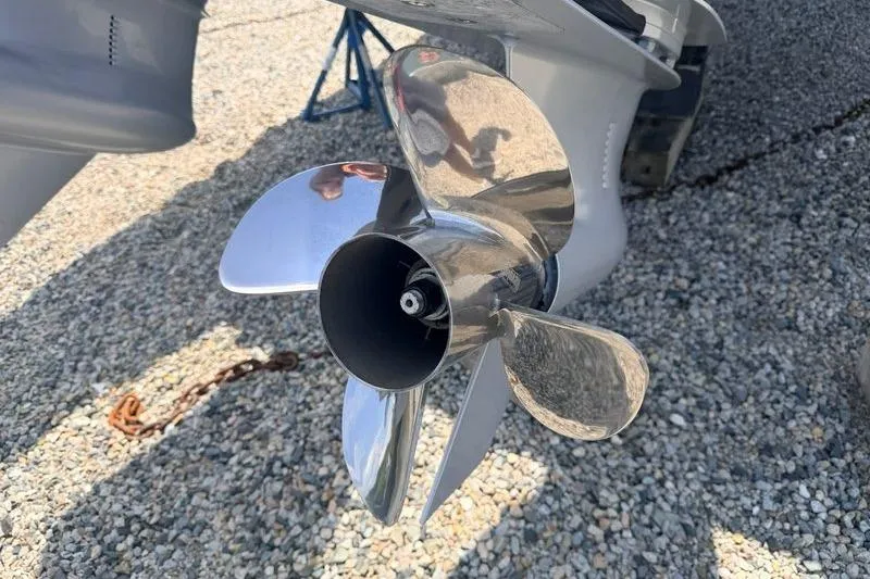 Slide: The Image of Close-up of a Saxdor 320 GTC 2025 boat propeller on gravel surface. - 54