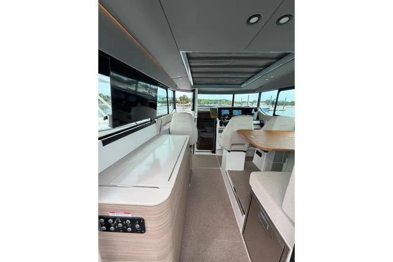 Slide: The Image of Interior of 2025 Saxdor 320 GTC boat, featuring modern seating and navigation equipment. - 16