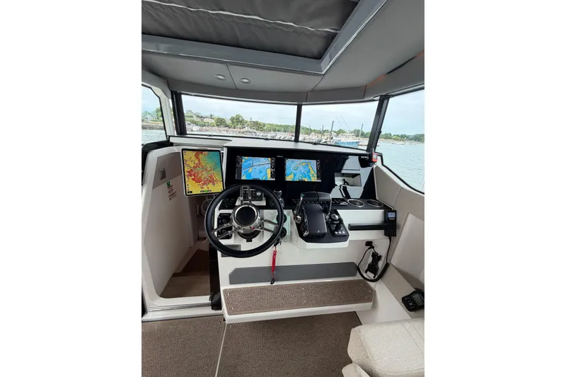 Slide: The Image of Interior cockpit of 2025 Saxdor 320 GTC boat with advanced navigation displays. - 25