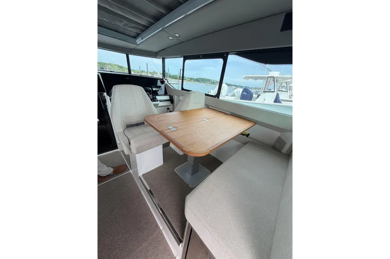 Slide: The Image of Interior of 2025 Saxdor 320 GTC boat with seating and wooden table. - 17