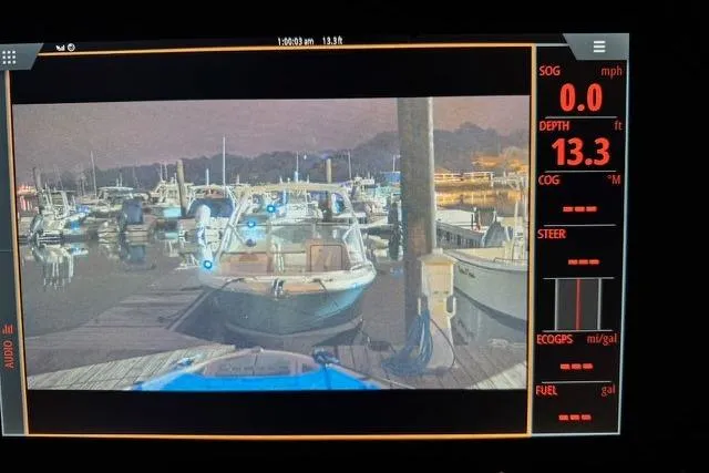 Slide: The Image of Display screen showing Saxdor 320 GTC at marina, depth 13.3 feet, nighttime setting. - 34