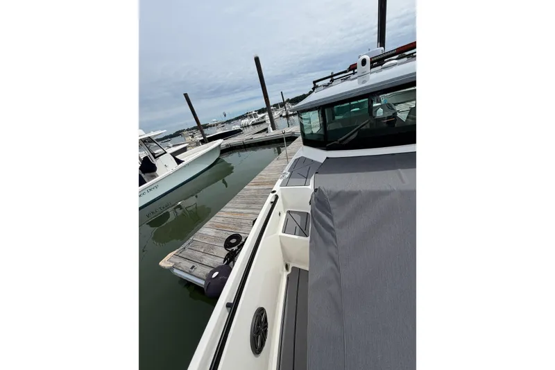 Slide: The Image of 2025 Saxdor 320 GTC docked at marina, showcasing sleek design and modern features. - 15
