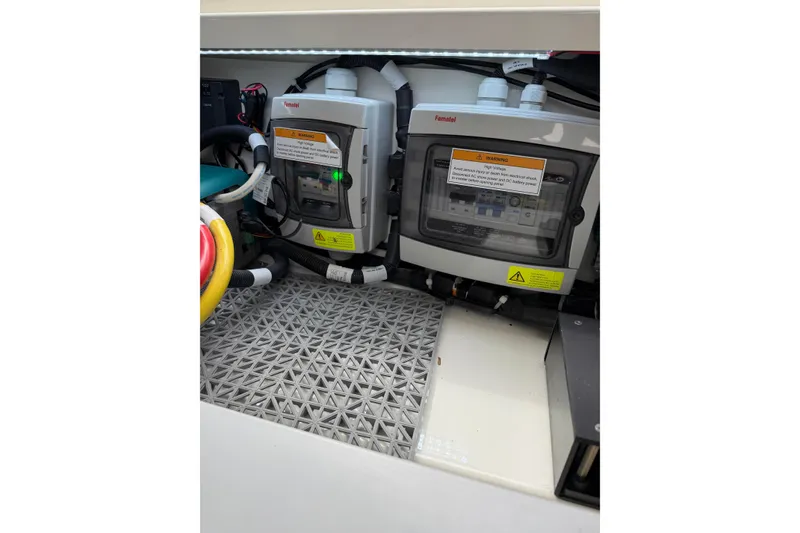 Slide: The Image of Electrical panel inside 2025 Saxdor 320 GTC boat, featuring warning labels and wiring. - 44