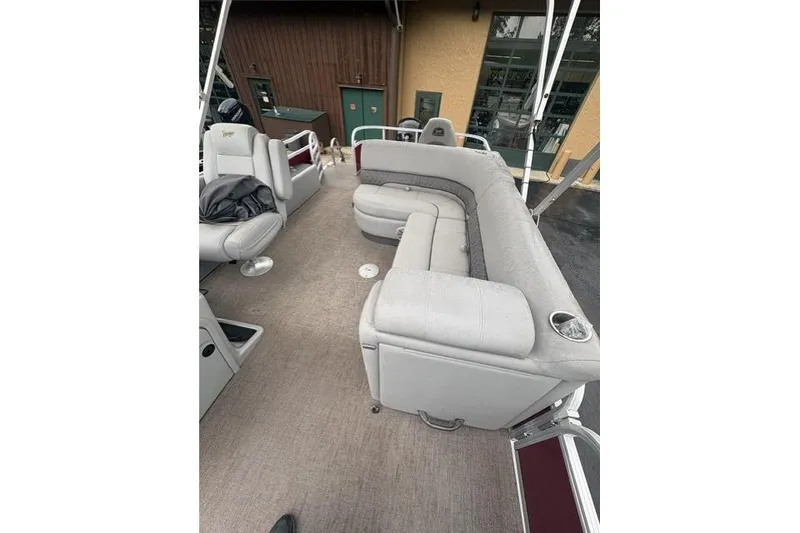 Slide: The Image of 2023 Ranger 220FC boat interior with gray seating and carpeted floor. - 6