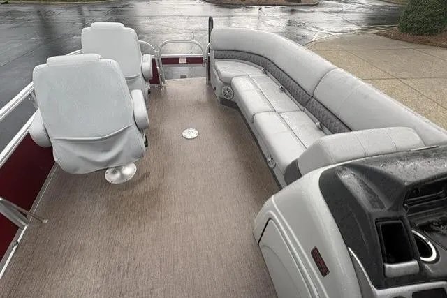 Slide: The Image of 2023 Ranger 220FC boat interior with gray seating and steering console. - 7