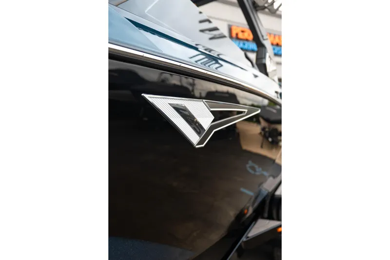 Slide: The Image of 2024 Tigé Z5 boat emblem on sleek black exterior. - 12