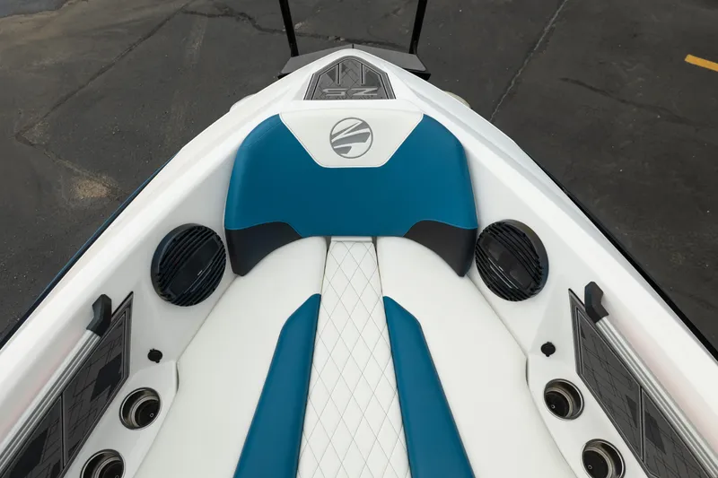 Slide: The Image of 2024 Tigé Z5 boat interior with blue and white seating, speakers, and cup holders. - 13