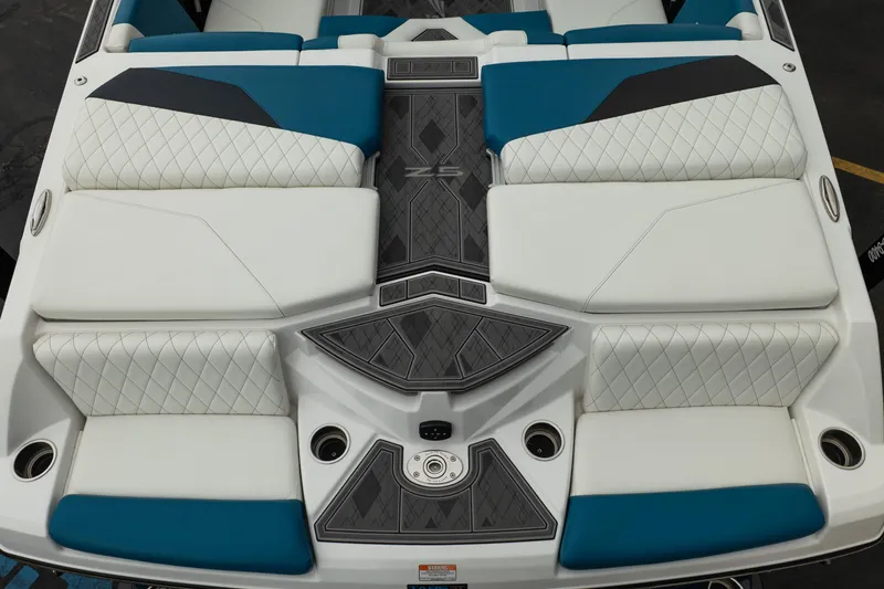 Slide: The Image of 2024 Tigé Z5 boat interior with white and blue diamond-stitched seating and sleek design. - 14