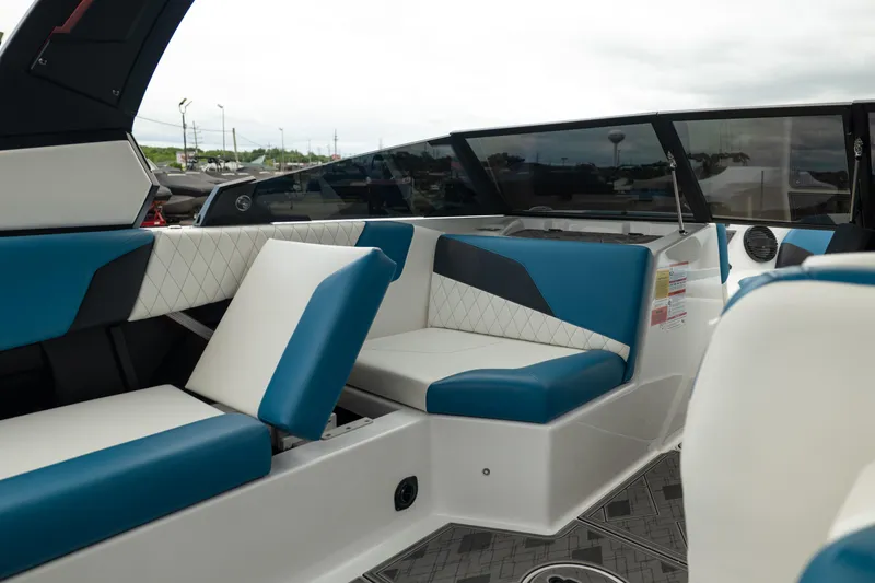 Slide: The Image of 2024 Tigé Z5 boat interior with blue and white seating, showcasing modern design. - 19