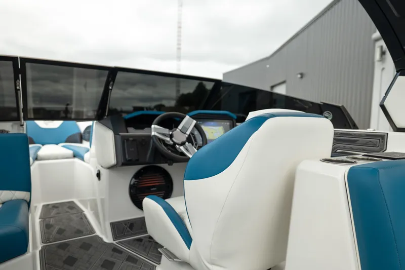 Slide: The Image of 2024 Tigé Z5 boat interior with blue and white seating, modern dashboard, and steering wheel. - 20