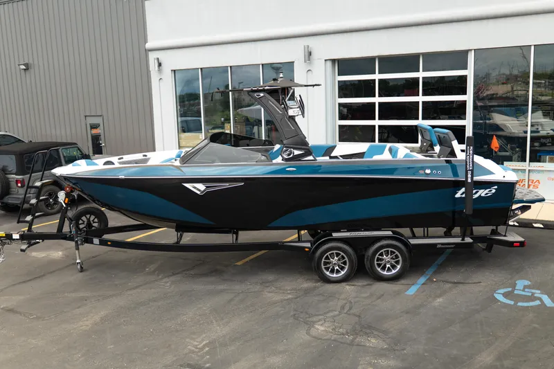 Slide: The Image of 2024 Tigé Z5 boat on trailer, parked outside dealership, showcasing sleek design and modern features. - 3
