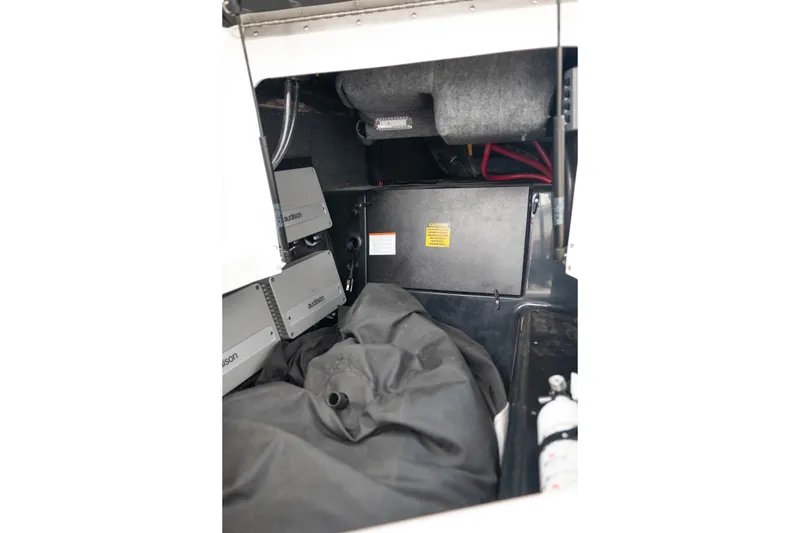 Slide: The Image of Interior view of 2024 Tigé Z5 boat storage compartment with equipment and safety gear. - 30