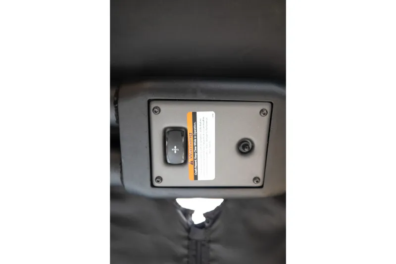 Slide: The Image of 2024 Tigé Z5 boat control panel with warning label and switch. - 33