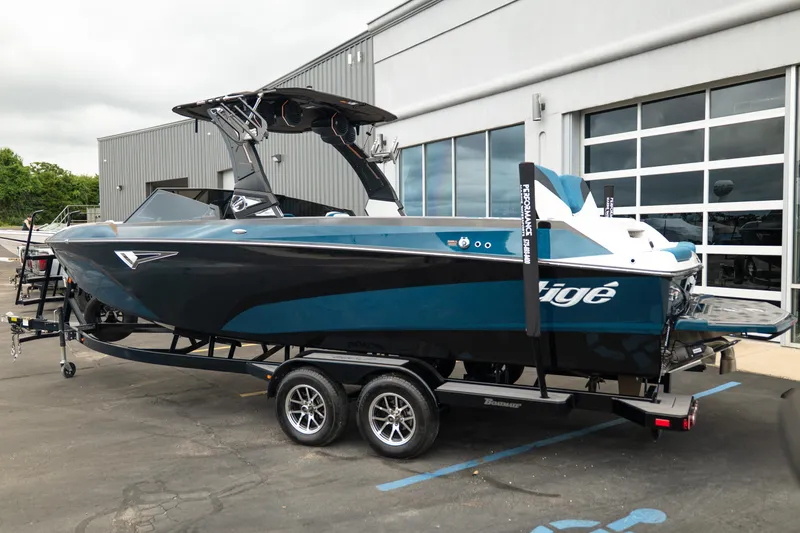 Slide: The Image of 2024 Tigé Z5 boat on trailer outside a modern building. - 4