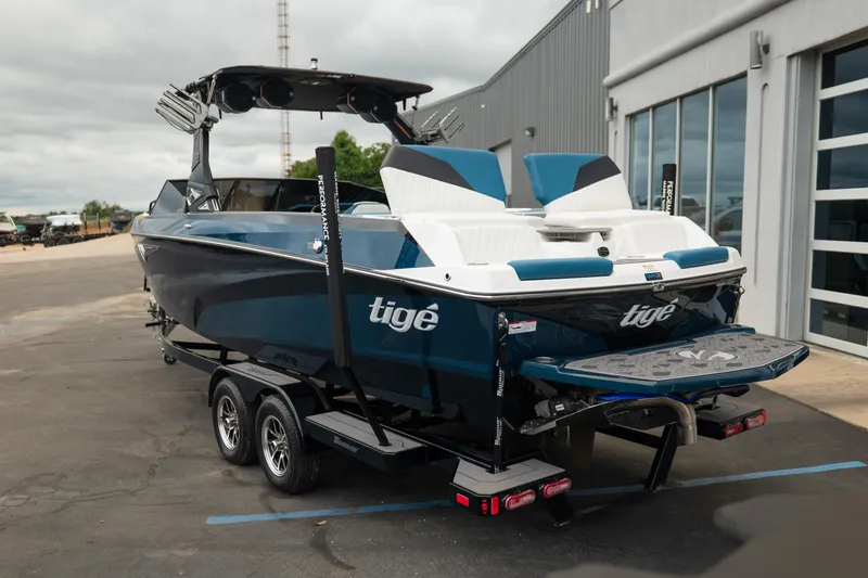 Slide: The Image of 2024 Tigé Z5 boat on trailer, parked outside a modern building. - 5
