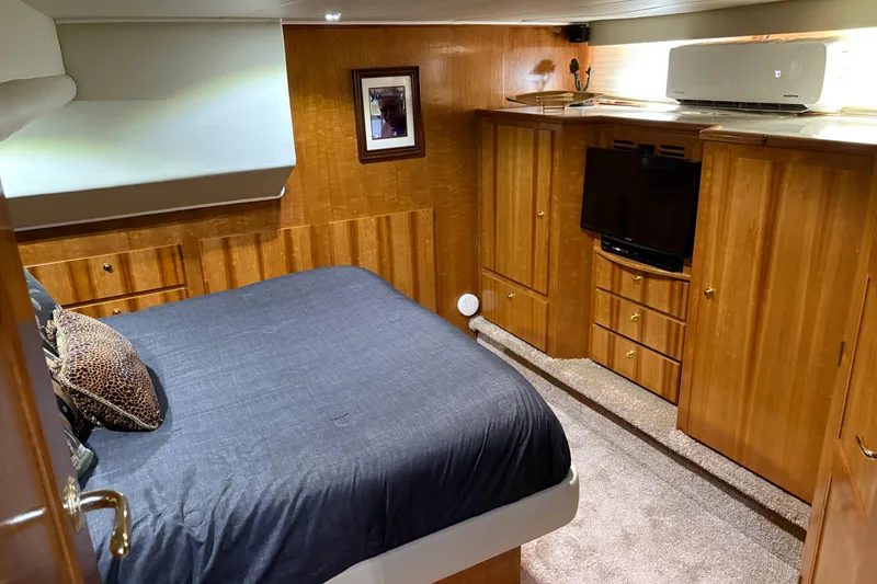 Slide: The Image of Luxurious bedroom in 2001 Navigator Yacht 5600 Pilothouse Classic with wood cabinetry and modern amenities. - 13