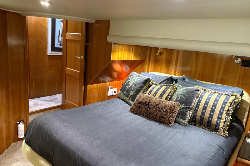 Slide: The Image of Luxurious bedroom in 2001 Navigator Yacht 5600 Pilothouse Classic with elegant wood paneling. - 14