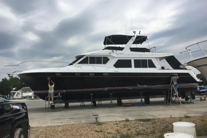 Slide: The Image of 2001 Navigator Yacht 5600 Pilothouse Classic being serviced on land. - 2