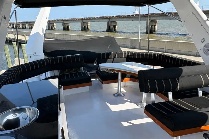 Slide: The Image of Luxurious seating area on 2001 Navigator Yacht 5600 Pilothouse Classic, docked by a scenic bridge. - 20