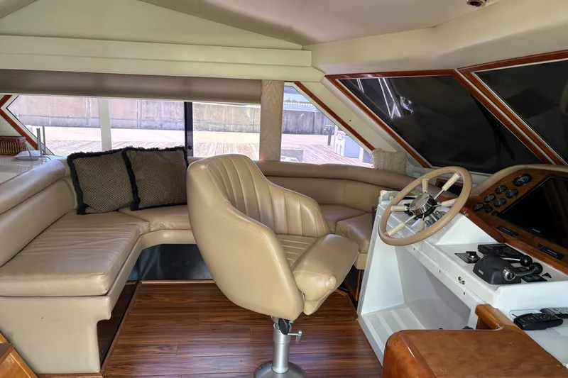 Slide: The Image of Interior of 2001 Navigator Yacht 5600 Pilothouse Classic with leather seating and helm. - 25