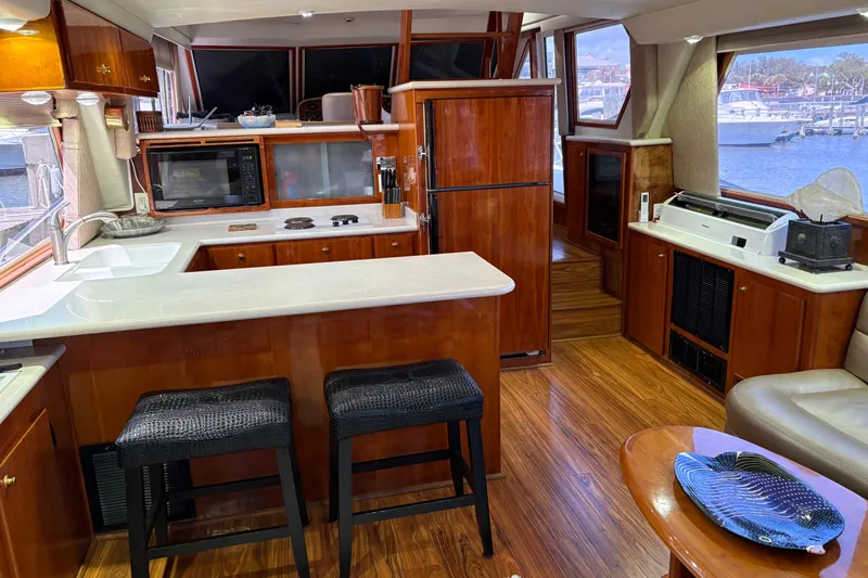 Slide: The Image of Luxurious 2001 Navigator Yacht 5600 Pilothouse Classic interior with modern kitchen and elegant wood finishes. - 26