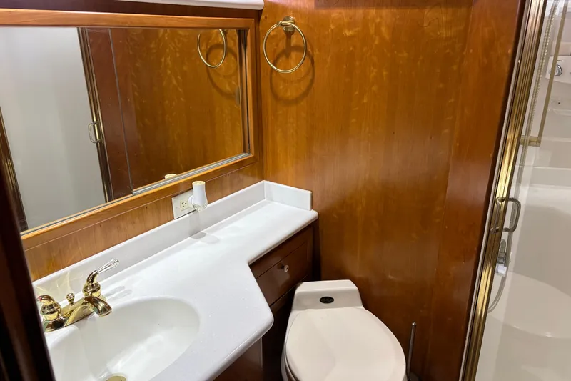 Slide: The Image of Luxurious bathroom in 2001 Navigator Yacht 5600 Pilothouse Classic with wood paneling and modern fixtures. - 29