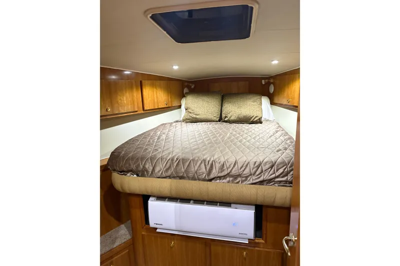 Slide: The Image of Cozy bedroom in 2001 Navigator Yacht 5600 Pilothouse Classic with wood cabinets and skylight. - 30