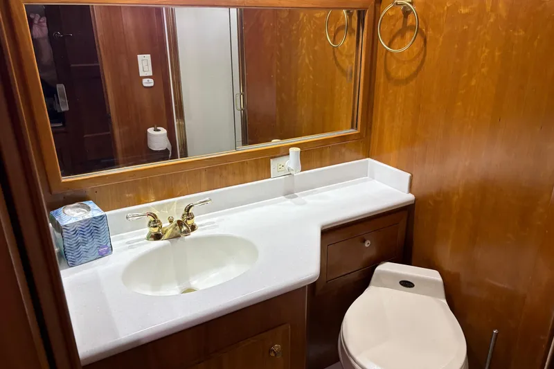 Slide: The Image of Luxurious bathroom in 2001 Navigator Yacht 5600 Pilothouse Classic with wooden cabinetry. - 31