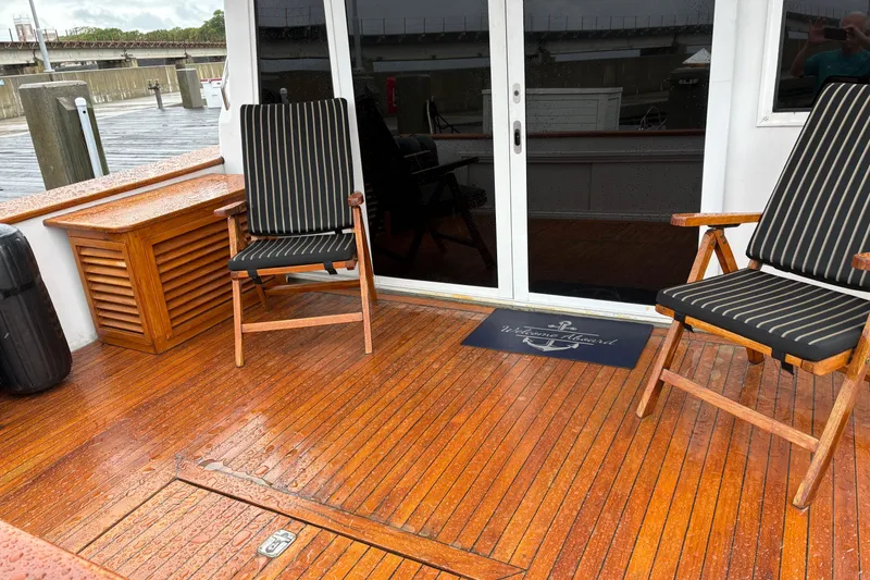 Slide: The Image of Wooden deck of 2001 Navigator Yacht 5600 Pilothouse Classic with chairs and welcome mat. - 34