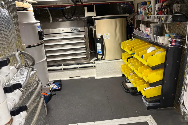Slide: The Image of Engine room of 2001 Navigator Yacht 5600 Pilothouse Classic with organized tools and equipment. - 35