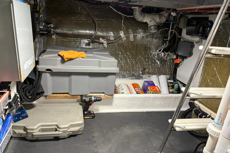 Slide: The Image of Engine room of 2001 Navigator Yacht 5600 Pilothouse Classic with tools and supplies. - 36