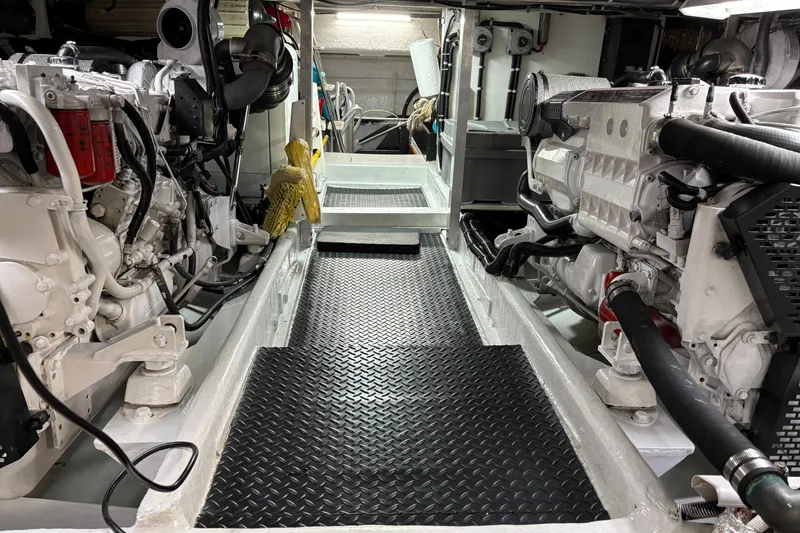 Slide: The Image of Engine room of 2001 Navigator Yacht 5600 Pilothouse Classic, featuring dual engines and clean layout. - 37