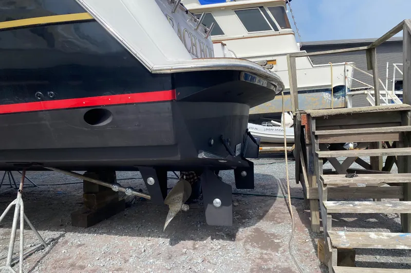 Slide: The Image of 2001 Navigator Yacht 5600 Pilothouse Classic on dry dock, showcasing hull and propeller. - 8