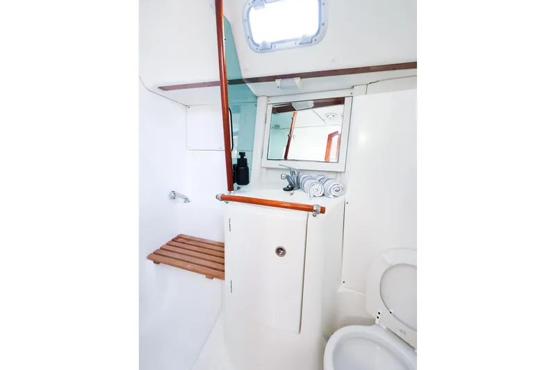 Slide: The Image of Bathroom interior of 2002 Beneteau Oceanis Clipper 361 yacht, featuring mirror and wooden accents. - 57