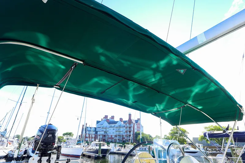 Slide: The Image of Beneteau Oceanis Clipper 361 sailboat with green canopy, docked in a marina, 2002 model. - 8