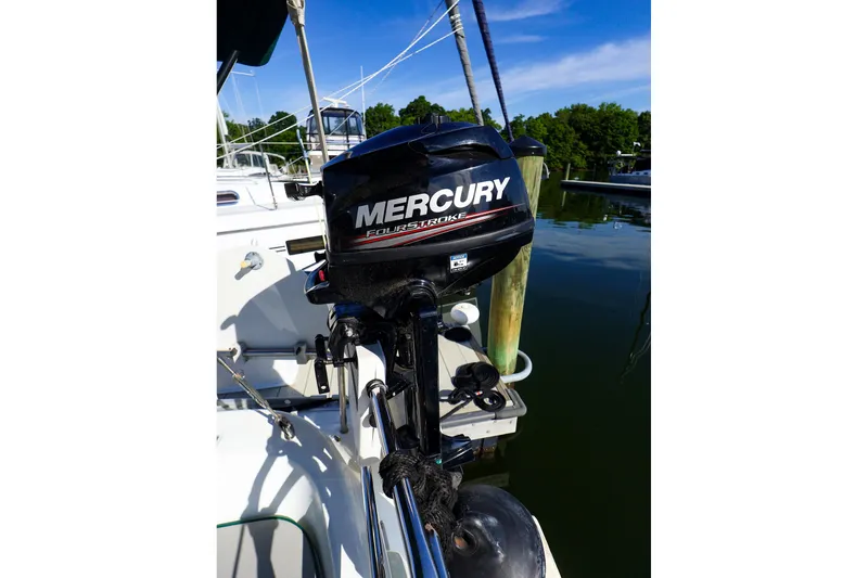 Slide: The Image of Mercury outboard motor on 2002 Beneteau Oceanis Clipper 361 sailboat, docked by calm waters. - 33