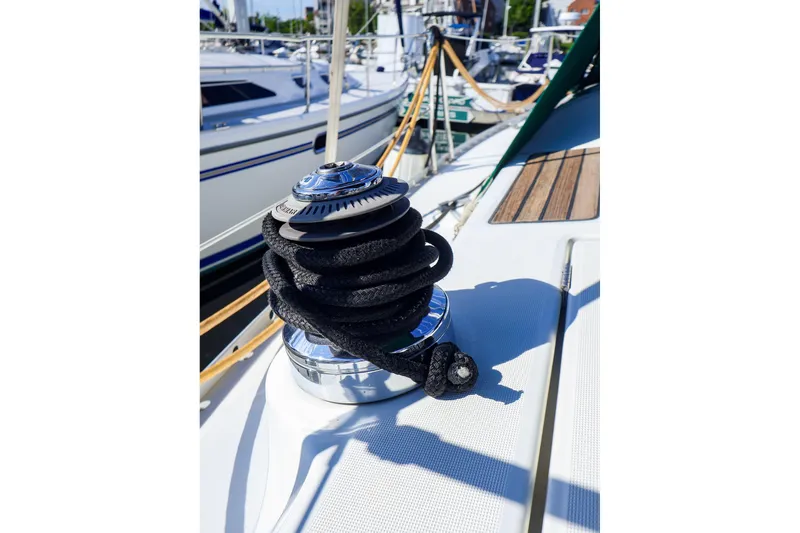 Slide: The Image of Winch on 2002 Beneteau Oceanis Clipper 361 sailboat deck, with coiled rope. - 34