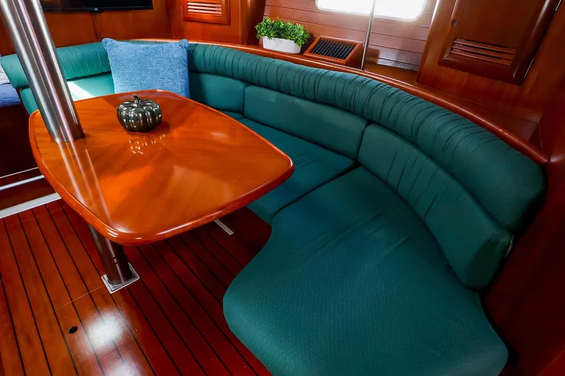 Slide: The Image of Luxurious interior of 2002 Beneteau Oceanis Clipper 361 with elegant wood finish and green seating. - 42