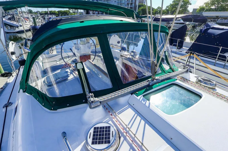Slide: The Image of 2002 Beneteau Oceanis Clipper 361 sailboat with green canopy, docked in marina. - 4